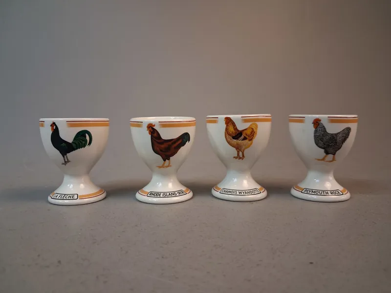 4 Äggkoppar. Rörstrand, "Tuppar", Motiv 3, 4, 7 & 8.